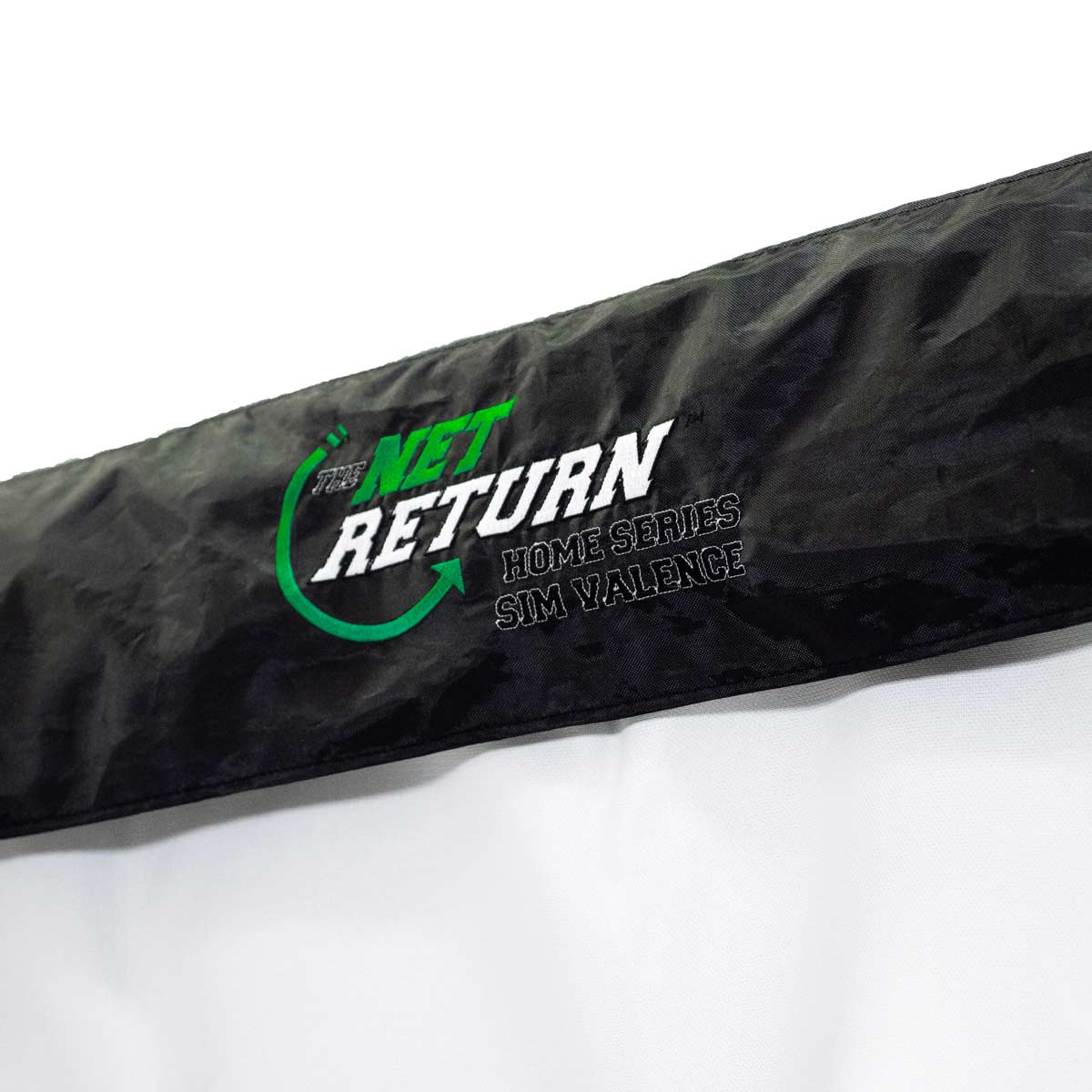 Close-up of a black fabric with "Simulator Kit" by The Net Return logo in green and white—perfect for any home golf simulator or garage setup.