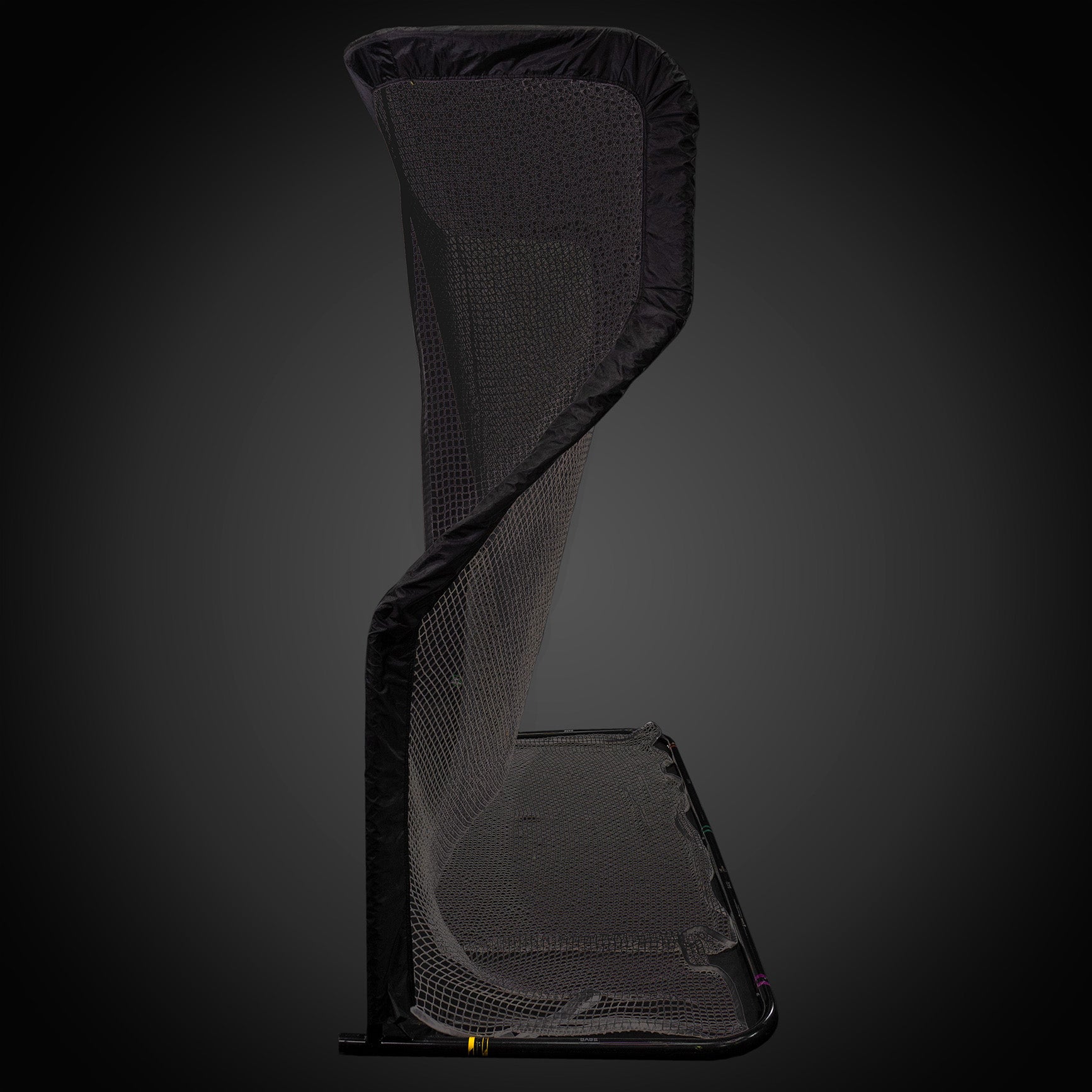 A tall, curved black sports net standing against a dark background.