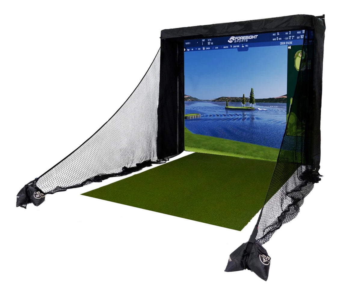 Golf simulator setup with a screen displaying a lake and green field, surrounded by netting, and a green mat in front.