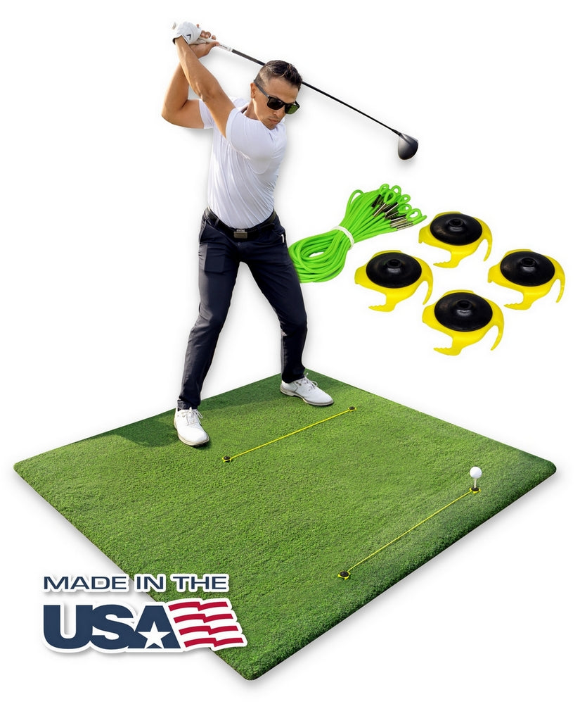 Tee Claw anchoring a wooden tee in a hitting mat, black and yellow