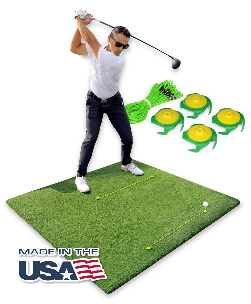Tee Claw anchoring a wooden tee in a hitting mat, green and yellow