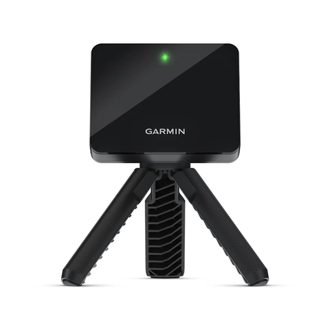 A black Uneekor Garmin Approach R10 portable launch monitor with a green indicator light is mounted on a compact tripod with textured legs, shown against a plain white background—ideal for practice at the driving range.