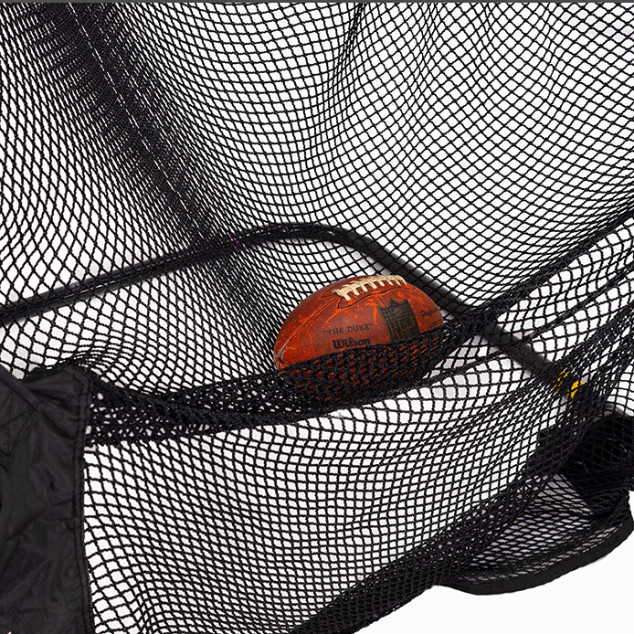 A football is caught in a black net with white background visible through the mesh.