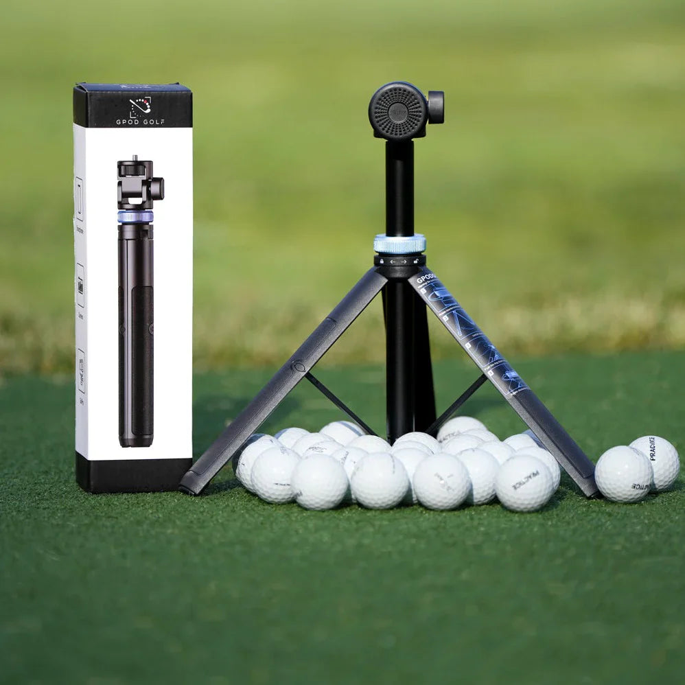 A GPOD GOLF GPOD Travel tripod with Sportsbox 3D Player Annual + Swing Analysis, shown on artificial turf beside white golf balls, is ideal for golf swing analysis, with a blurred green background.