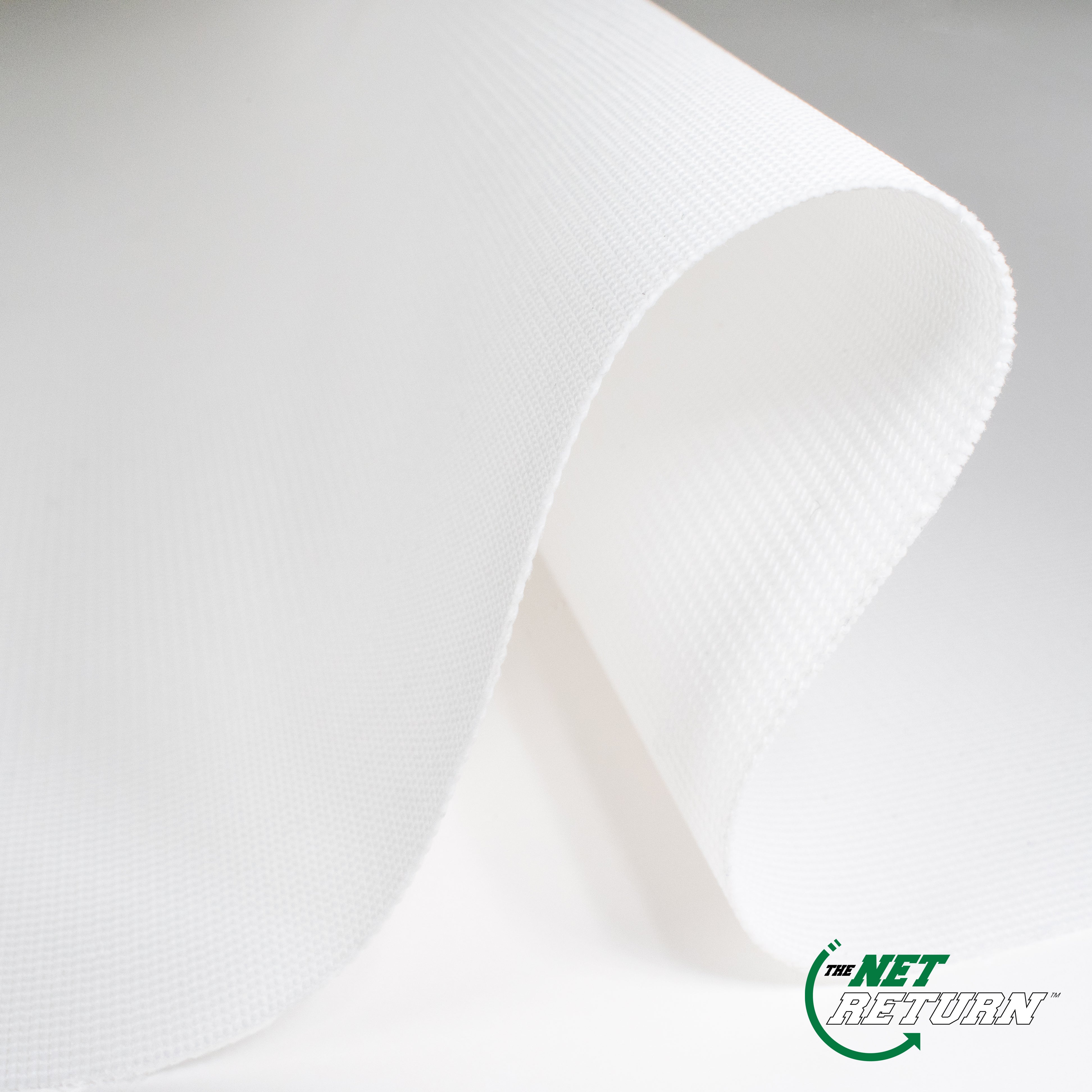 A close-up of a white fabric roll with a textured surface, showcasing the brand logo "The Net Return" in the bottom right corner.