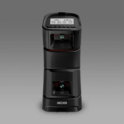Black UNEEKOR golf launch monitor on a gray background, featuring two circular sensors and a digital display on top.