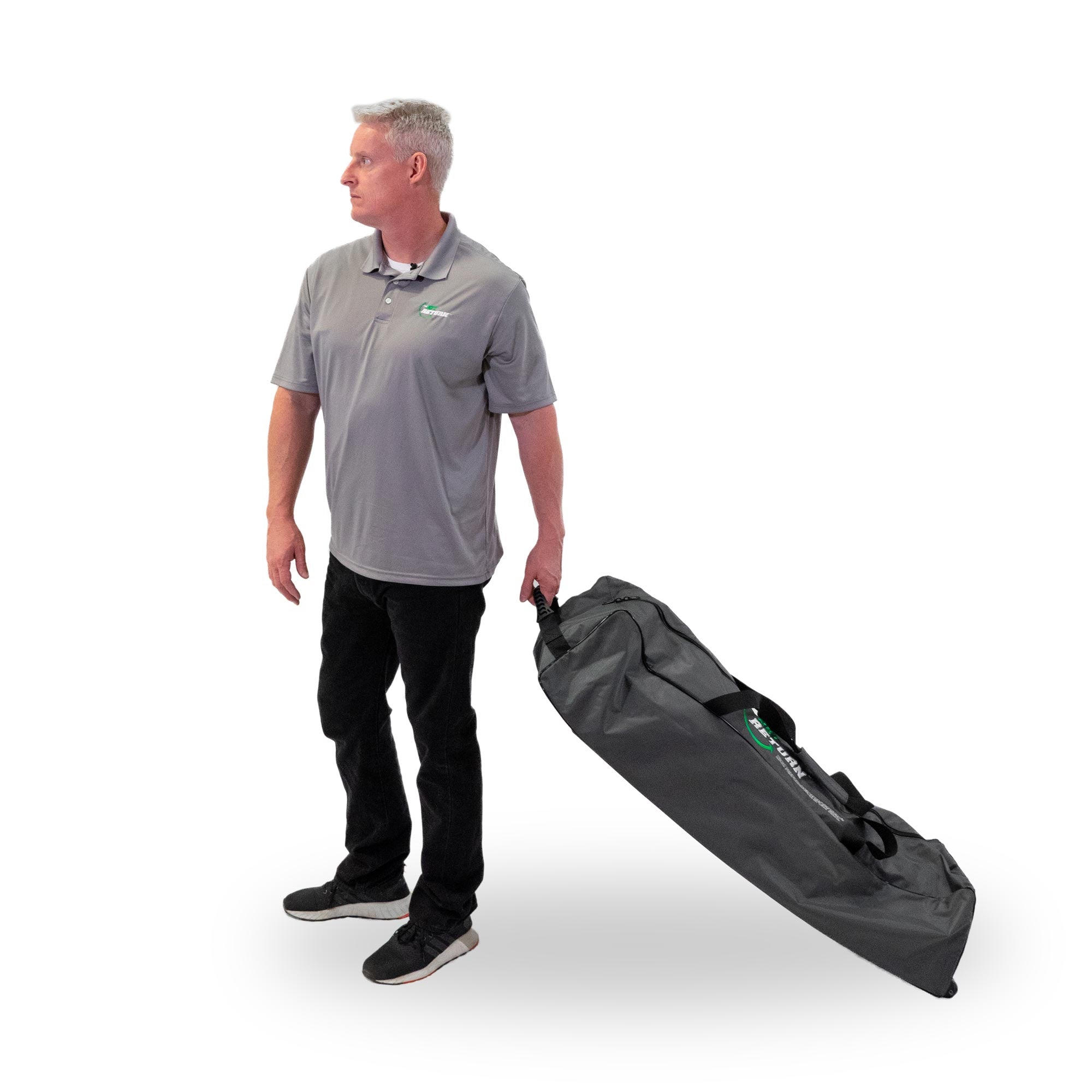 Man in a gray shirt and black pants holding a large black carry bag on a white background.