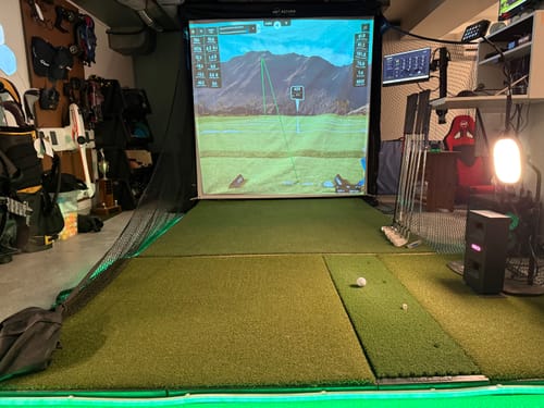 Net Return Pro Series set up as a full home golf simulator with screen and projector